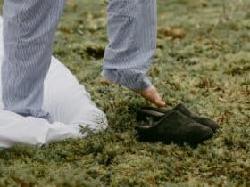 A person steps into slippers outdoors, embracing a cozy morning vibe.