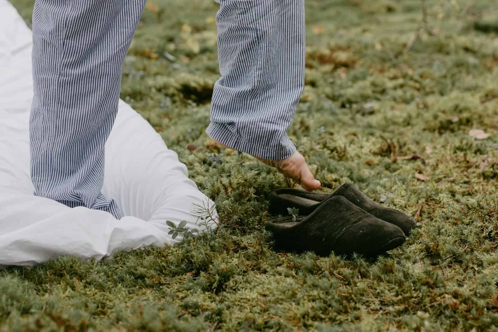 A person steps into slippers outdoors, embracing a cozy morning vibe.